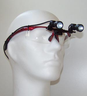 ErgonoptiX-D-Light-Duo-HD-shadowless-surgery-headlight-on-red-frames.jpg